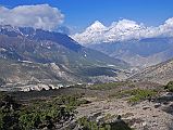 11 Dhaulagiri And Tukuche Peak Early Morning On Trail To Mesokanto La I turned around on the trail towards Mesokanto La and watched the clouds boil up towards Dhaulagiri and Tukuche Peak. The trail continues up the side of the valley from the kharka (3460m) and then splits in two  the left going to the Tilicho eastern pass (5200m), while we took the right path to try and cross the Mesokanto La (5100m).